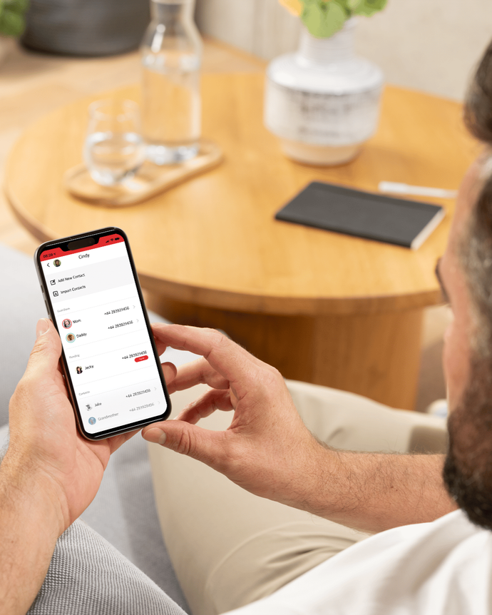 Parent adding new contacts to their childs kids smartwatch. A good kids smartwatch has only approved contacts and is controlled through a parental app.